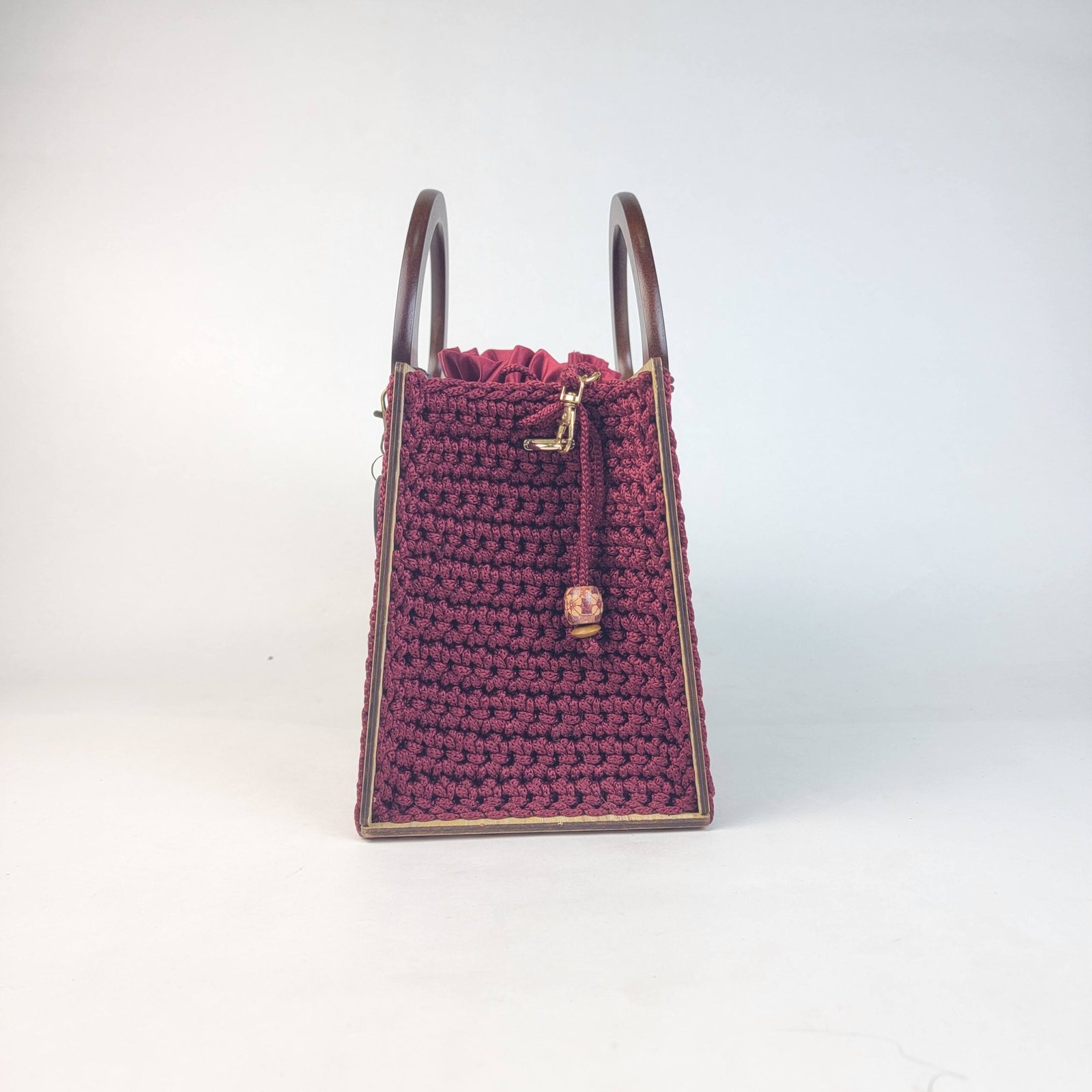 Daafua large-wood carved plate crochet handbag