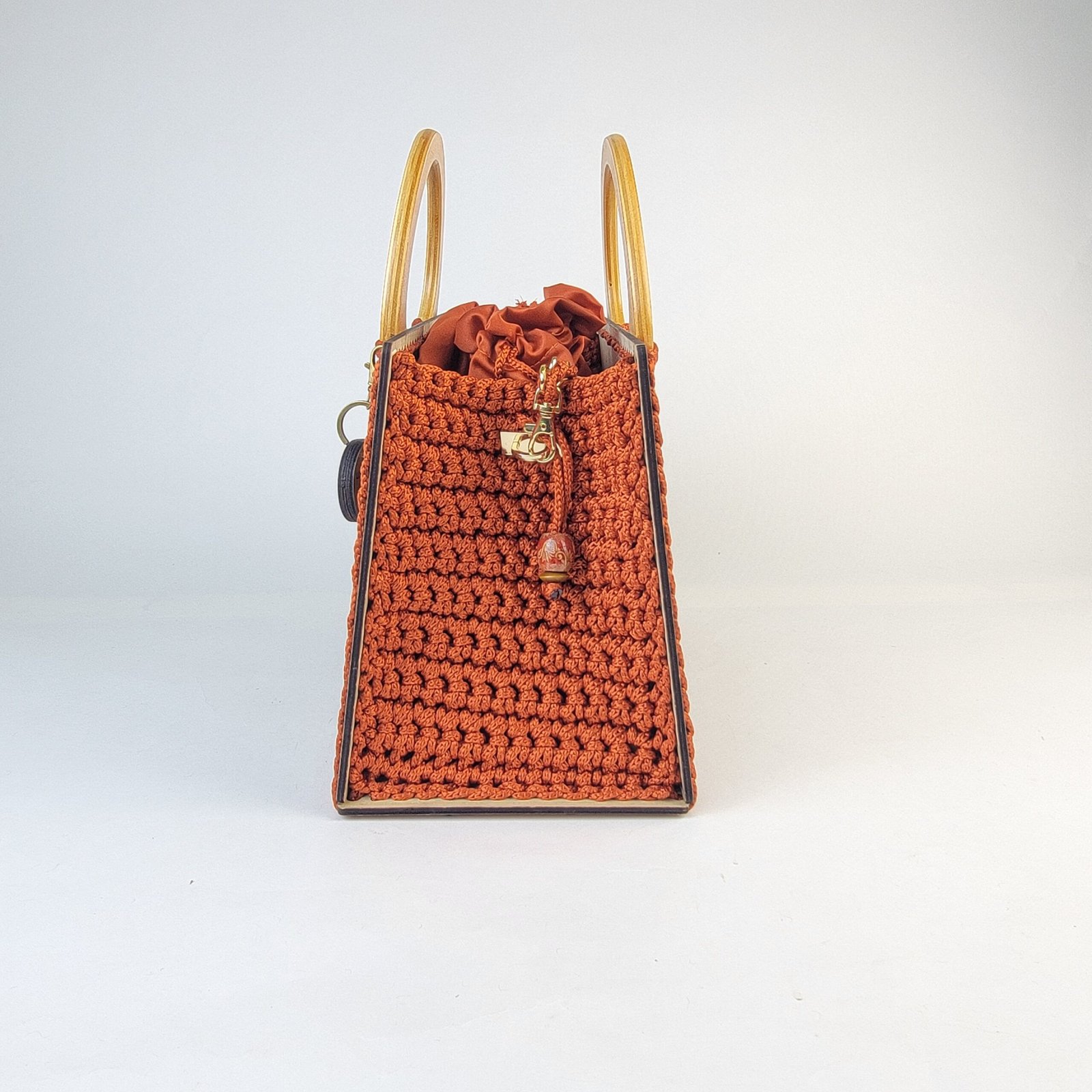 Daafua large-wood carved plate crochet handbag